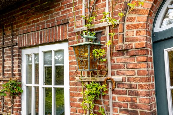 Glaslaterne und Rosenstock am Eingang von Haus Margarete